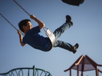 A kid playing happily thanks to your efforts to childproof your yard and garden