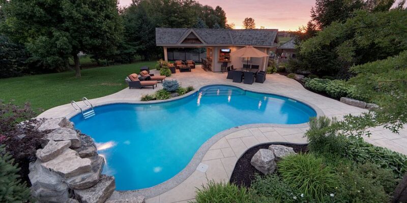 Should I put wood or stone around my pool?