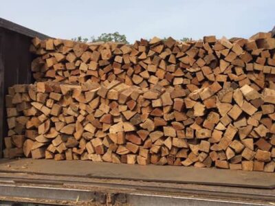 A truck full of logs being loaded.