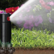 A sprinkler system watering a lawn