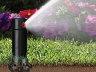 A sprinkler system watering a lawn