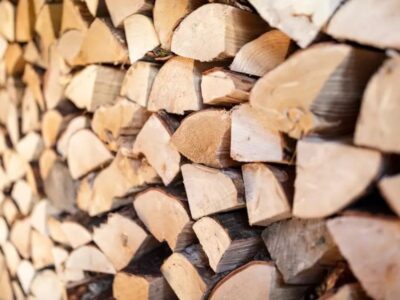 A wall adorned with a stack of logs, potentially firewood in a rick