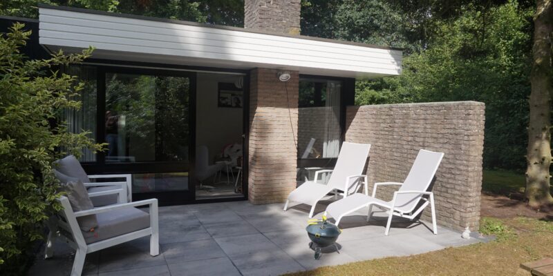 A simple patio with two chairs and a table