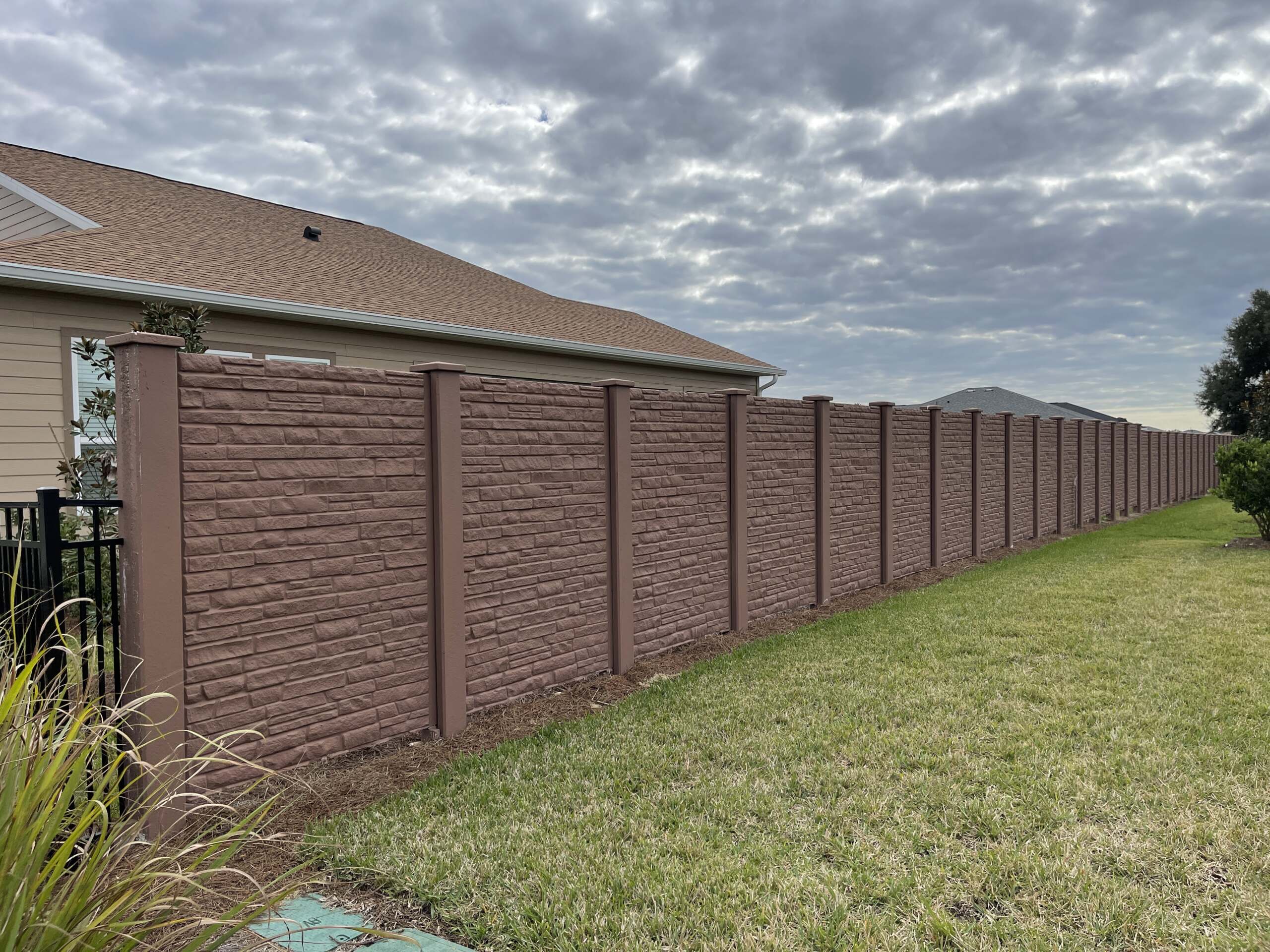 A brown brick fence. Faster Completion