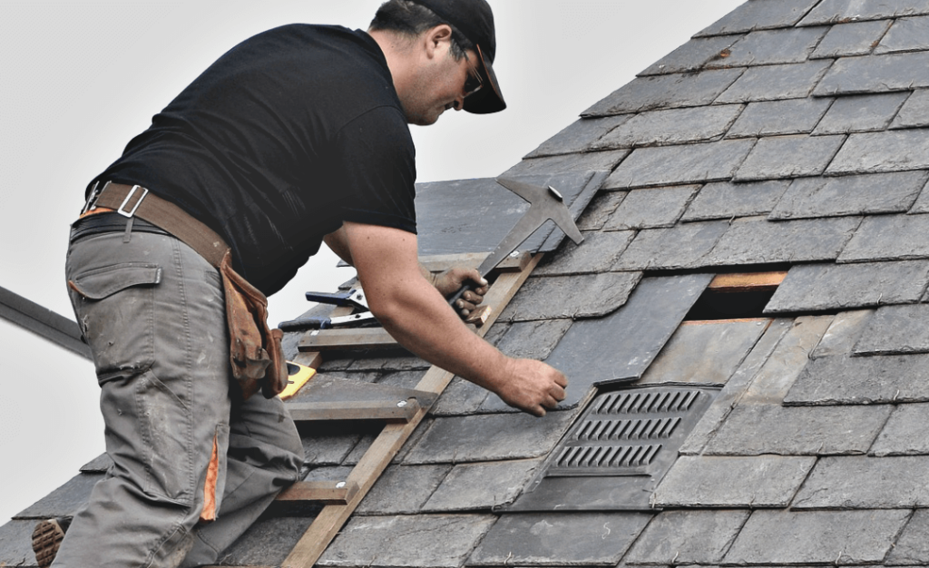 A man working on a roof with a ladder.