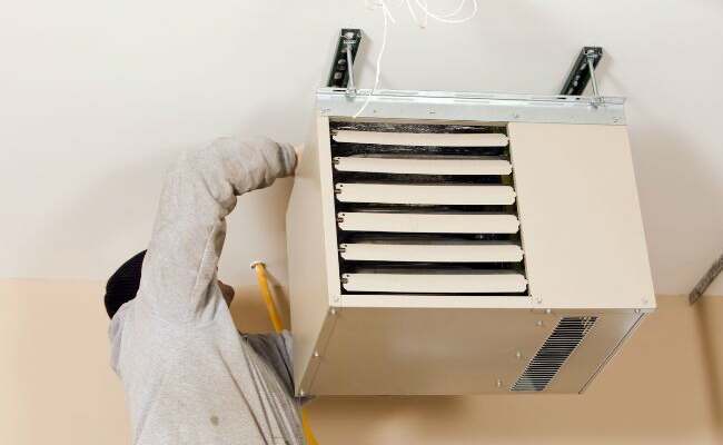 a man fixing a heater